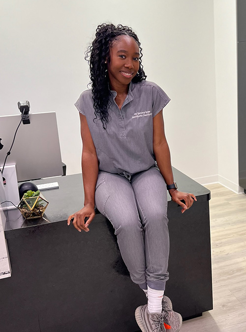 Dr. Ijeoma Igwe sitting on desk